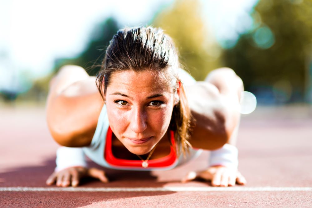 young beautiful woman doing push ups outdoors on a 2023 11 27 04 59 28 utc 1